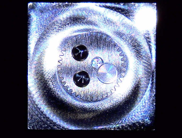 Micro Component Sample (Lower Magnification)
                    • Outer: Micro Gear with Minimum R0.1mm
                    • Center: Micro Holes, φ0.1mm, 5 Holes
                    • Center Left: Micro Tapped Holes, M2, 2 Holes