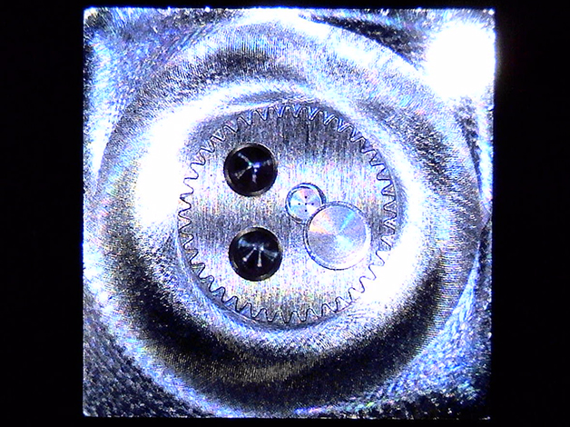 Micro Component Sample (Lower Magnification)
      •	Outer: Micro Gear with Minimum R0.1mm
      •	Center: Micro Holes, φ0.1mm, 5 Holes
      •	Center Left: Micro Tapped Holes, M2, 2 Holes
      